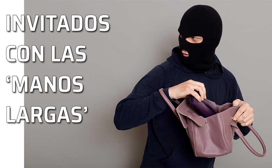 Objetos robados fiesta. Un ladrón sustrae algo del bolso de una mujer