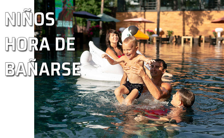 Consejos niños hora de bañarse. Un padre disfruta de la piscina con su familia