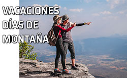 Icono vacaciones montaña Pareja divisa el paisaje desde lo alto de una montaña